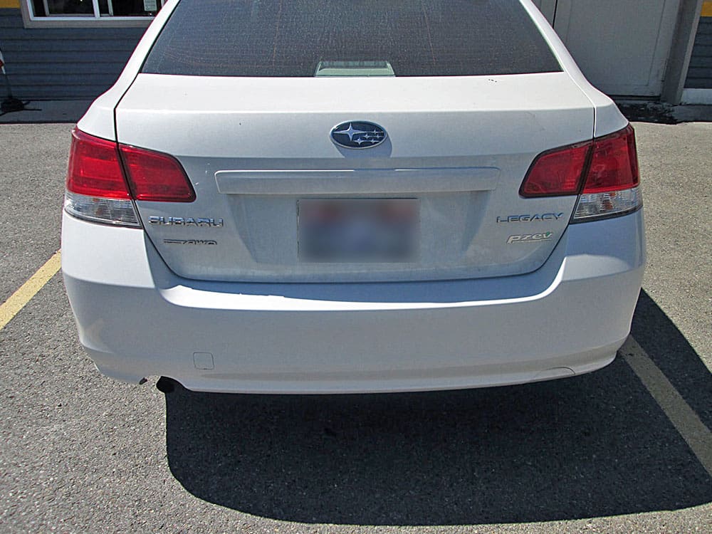 Image of the same Subaru Legacy after rear bumper repair, looking new